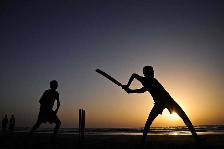 Batsman hitting a powerful shot in stadium